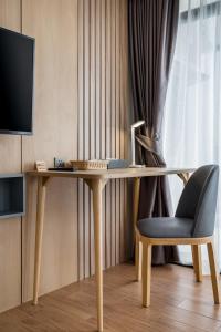 a wooden desk with a chair and a television at WEG NaiThon Beach in Nai Thon Beach +48 photos