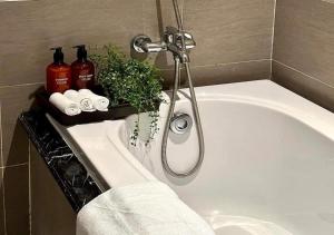 a bathroom with a bath tub with a shower at Apartment with Ocean view in Danang +8 photos