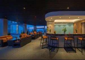 a lobby with chairs and a bar in a building at Apartment with Ocean view in Danang