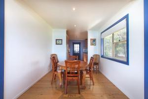 a dining room with a table and chairs at Spectacular Views in Mollymook