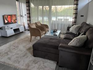 a living room with a couch and two chairs at House Legacy in Bihać