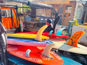 a group of surfboards sitting on top of a vehicle at PACIFICO SURF HOUSE - by the Sea in Shishikui