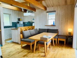a dining room with a wooden table and chairs at PACIFICO SURF HOUSE - by the Sea in Shishikui