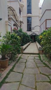 a stone walkway in front of a building at Suite Room in Apartments in Bangalore