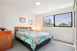 a bedroom with a bed and a window at Jade Waters U4 5 Latona Ave in Caloundra