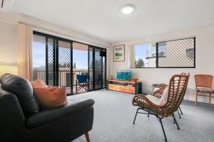 a living room with a couch and a chair at Jade Waters U4 5 Latona Ave in Caloundra