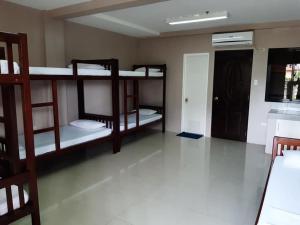 a room with three bunk beds and a hallway at EL SEÑOR JESUS APARTELLE in Ayusan Norte
