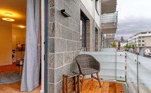 una silla se sienta en el balcón de un edificio en Km Style Apartments 7 en Friburgo de Brisgovia