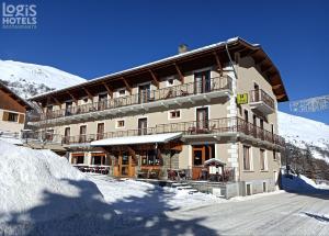 a large building on a snow covered mountain at Hôtel du Crêt Rond in Valloire