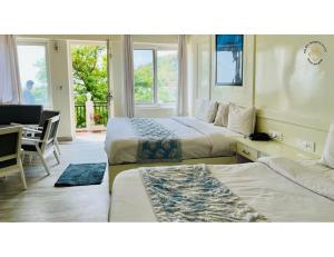 a hotel room with two beds and a desk at Hotel Diamond, Mussoorie in Mussoorie