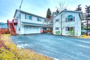 a white house with a garage and a driveway at Serene Retreat Charming 2 Bedroom Apt Sleeps 4 in Kodiak