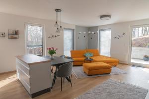 a living room with a couch and a table at Tölgyes Villa in Kőszeg