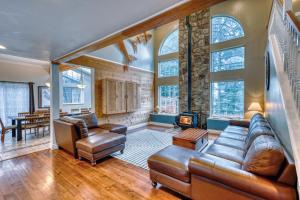 a living room with leather furniture and a fireplace at Lodge Style Living Spacious 5BR Reunion Getaway in Kodiak