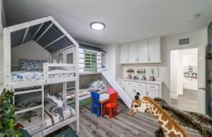 a room with two bunk beds and a giraffe at Safari Escape Disneyland 5 Bedroom 4 Bath Game Rm in Anaheim