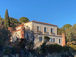 a large house on a hill with trees at Château de la Sybille, vue imprenable sur le Canigou et les Orgues d'Ille sur Têt in Ille-sur-Têt