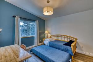 a bedroom with a bed and a table and a window at Lodge Style Living Spacious 5BR Reunion Getaway in Kodiak