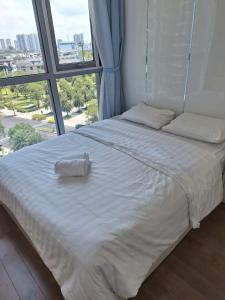 Posteľ alebo postele v izbe v ubytovaní Vinhomes Central Park (빈홈센트럴파크)