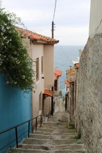 an alley with stairs leading down to the ocean at Kalys House in Kavála