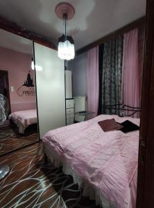 a bedroom with a large bed and a mirror at Kalys House in Kavála