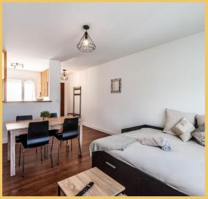 a bedroom with a bed and a table and chairs at Chez Jeremie Cluses in Cluses