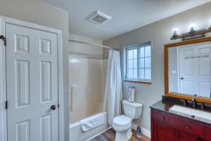 a bathroom with a toilet and a shower and a sink at Rustic Elegance 7 Bedrms 4 bath Cathedral Ceilings in Kodiak +81 photos