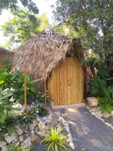 a small hut with a straw roof at Samui Circus Studio & Ville - Dome Bungalow 5 in Amphoe Koh Samui