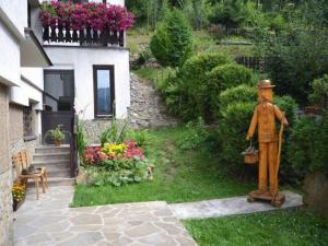 a statue of a man standing next to a house at Pensjonat Krokus in Szczyrk