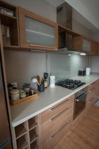 a kitchen with wooden cabinets and a stove at Nice&cozy flat No7 in Rīga