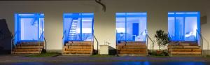 a group of blue doors on a building at 4lofts Fränkische Schweiz in Unterleinleiter