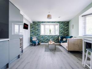 a living room with a couch and a table at The Ecclesian Deluxe Apartments near Trafford Centre Eccles Train Station in Manchester