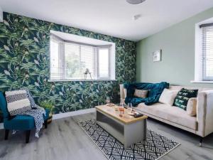 a living room with a couch and a table at The Ecclesian Deluxe Apartments near Trafford Centre Eccles Train Station in Manchester