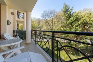 a balcony with a table and chairs and a view at Golden Sands 1BD Summer Retreat by Flat Mаnаger in Golden Sands