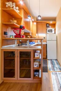 a kitchen with wooden cabinets and a white refrigerator at Golden Sands 1BD Summer Retreat by Flat Mаnаger in Golden Sands +13 photos