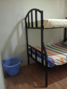 a bunk bed in a room with a basket at Nyakach Getaway Kisumu in Kap Sarok