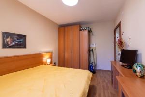 a bedroom with a bed and a television in it at Golden Sands 1BD Summer Retreat by Flat Mаnаger in Golden Sands