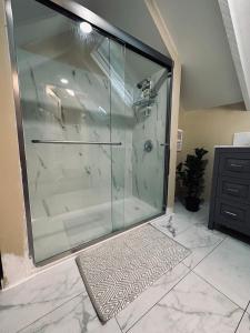 a shower with a glass enclosure in a bathroom at Roy & Soph Bright & Cozy Place in Glendale