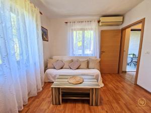 a living room with a bed and a table at Apartment Saria Strunjan in Strunjan