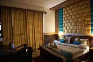 Ένα ή περισσότερα κρεβάτια σε δωμάτιο στο Hotel Joshimath Inn