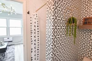 a living room with a wall with a geometric wallpaper at Charlotte tiny Home getaway 5 min to lake Wylie in Charlotte