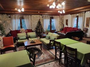 a living room with a christmas tree in the center at Hotel Kokkinos Vrachos in Elati