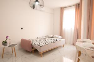 ein weißes Schlafzimmer mit einem Bett und einem Fenster in der Unterkunft S&B Apartment in Koper