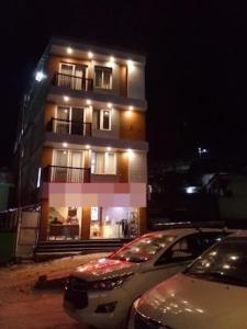 un edificio con coches aparcados delante de él por la noche en Hotel Badri, en Badrīnāth