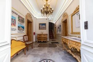 a home office with a chandelier and a hallway at Suite Orientale Maison de L'église du Couvent in Narbonne