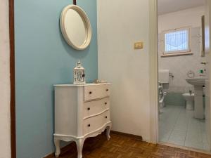 a bathroom with a white dresser and a mirror at Villa Bucchi in Lido di Spina +33 photos