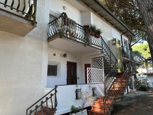 a house with stairs and a balcony at Villa Bucchi in Lido di Spina
