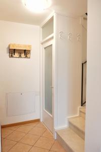 a hallway with white walls and stairs in a house at Casa Aaron in Tremosine Sul Garda