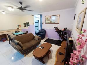 a living room with a couch and a table at Kota 3BR Townhouse 5 Pax - TVBox/Mahjong/Jonker in Melaka