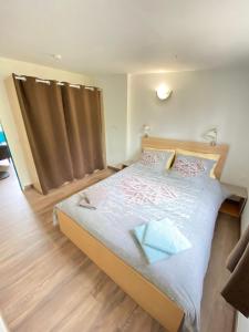 ein Schlafzimmer mit einem großen Bett in einem Zimmer in der Unterkunft Gîte les chênes verts - Périgord noir in Saint-Amand-de-Coly