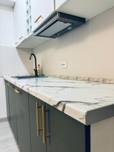 a kitchen with a sink and a counter top at Sudului ApartHotel in Bucharest