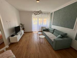 a living room with a couch and a tv at Darius in Tuzla